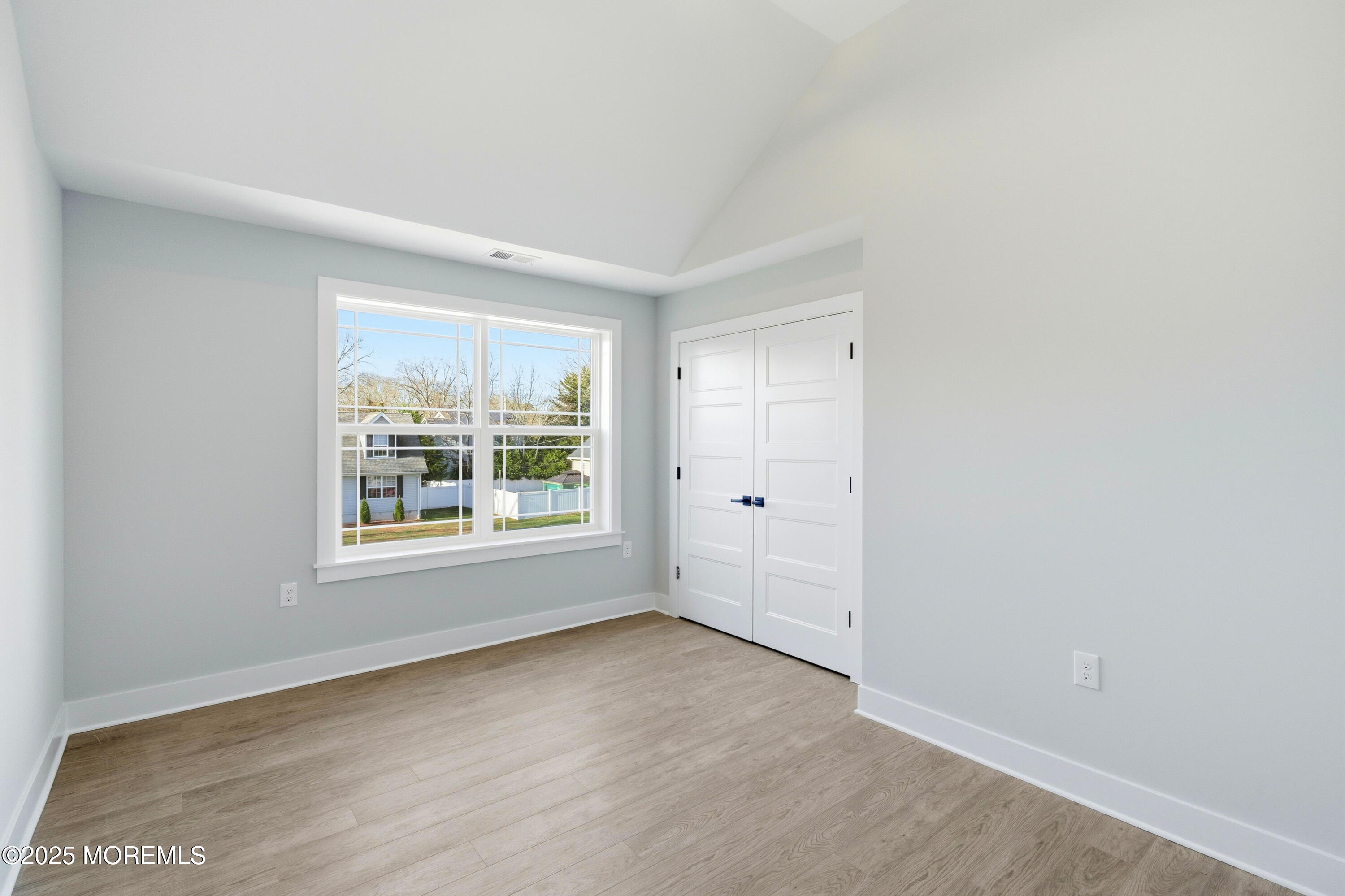 421 Roland Avenue Bayville, NJ 08721 - Photo 12 of 45 an empty room with wooden floor and windows