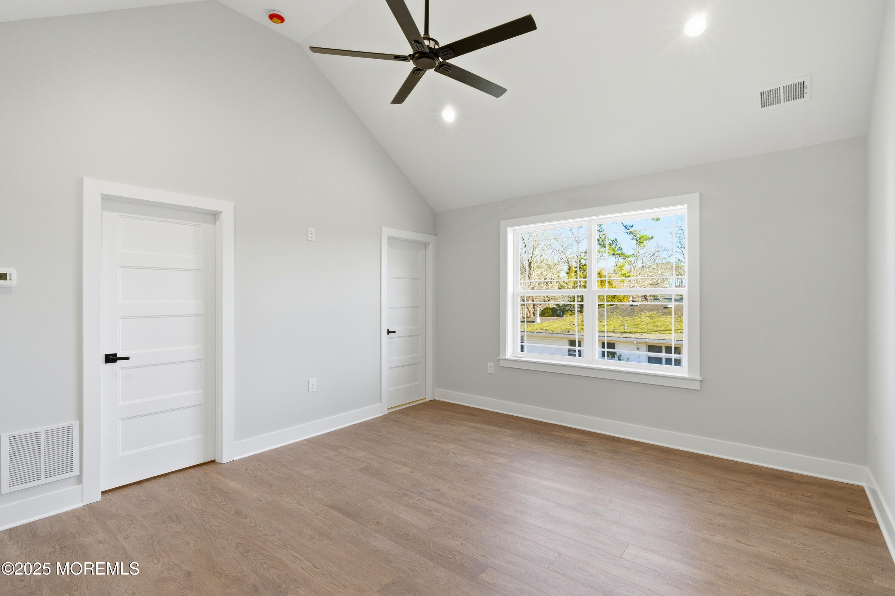 421 Roland Avenue Bayville, NJ 08721 - Photo 35 of 45 a view of an empty room with a window and a ceiling fan