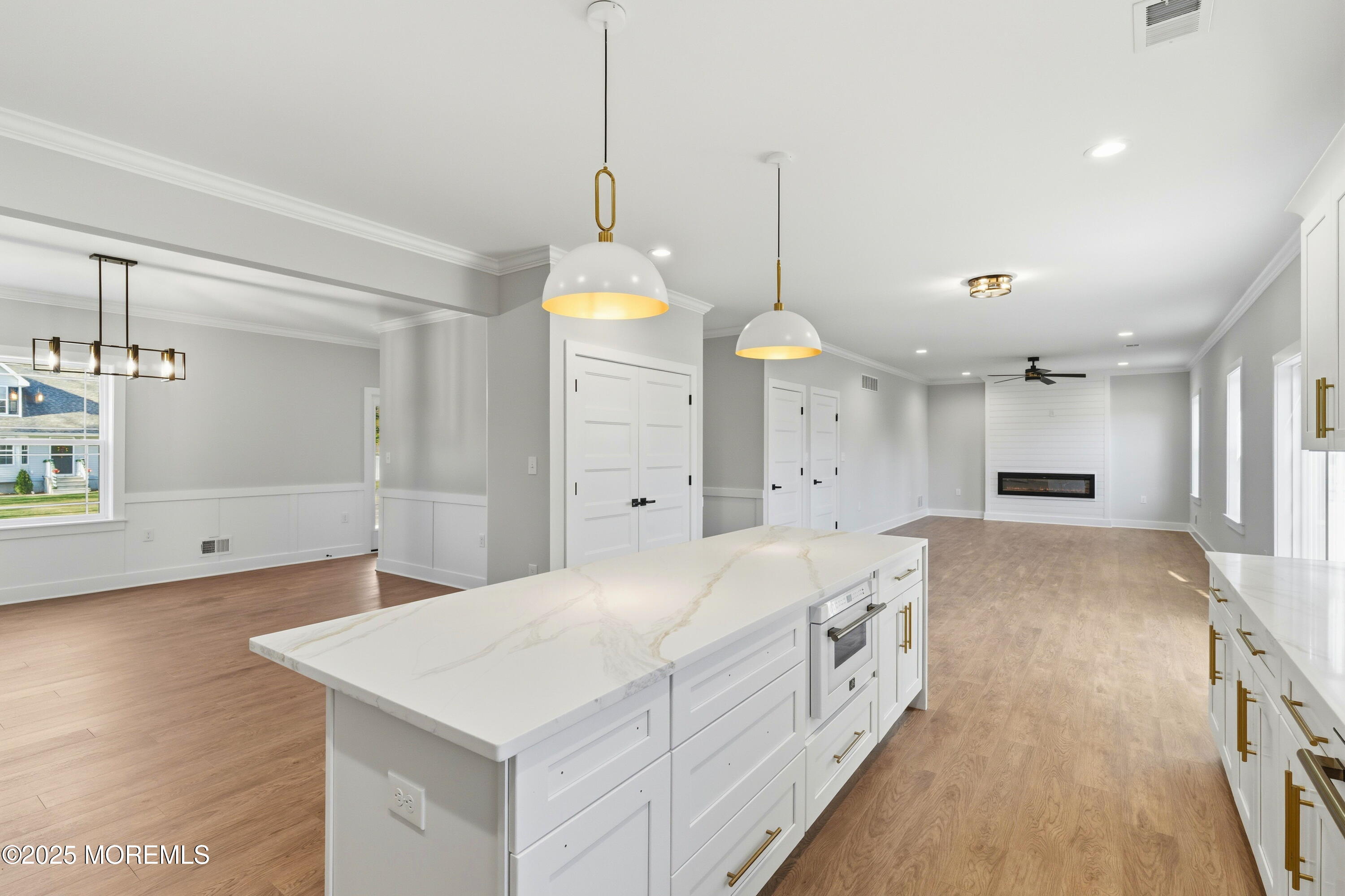 421 Roland Avenue Bayville, NJ 08721 - Photo 42 of 45 a large white kitchen with a large island oven a stove a sink a chimney and a window