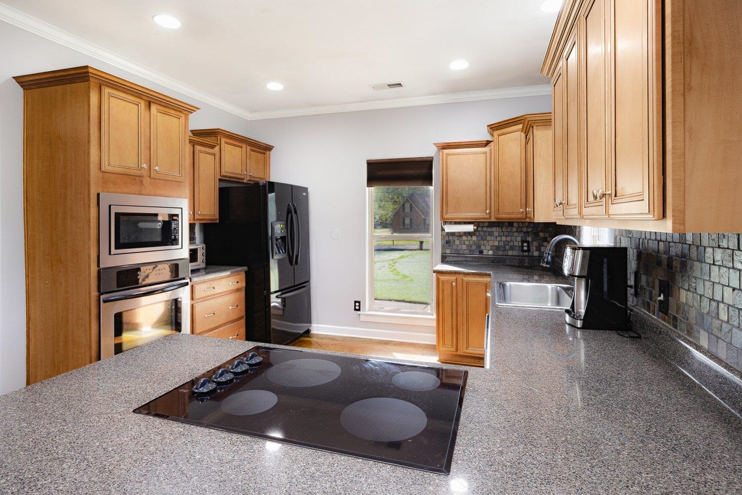 3965 Fonta Road Bartlett, TN 38135 - Photo 9 of 24 Kitchen featuring a sink, black appliances, decorative backsplash, visible vents, and recessed lighting