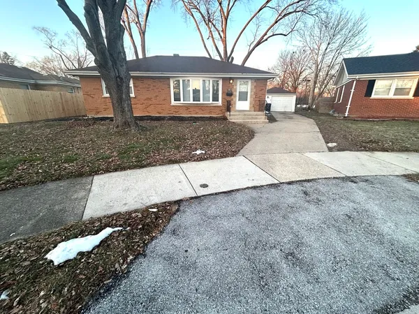 a front view of a house with a yard and a garage