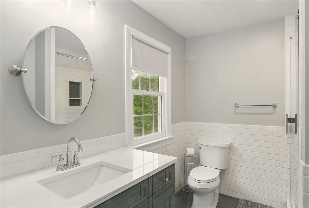 36 Buehler Road Bedford, MA 01730 - Photo 20 of 40 a bathroom with a toilet a sink a mirror and a window