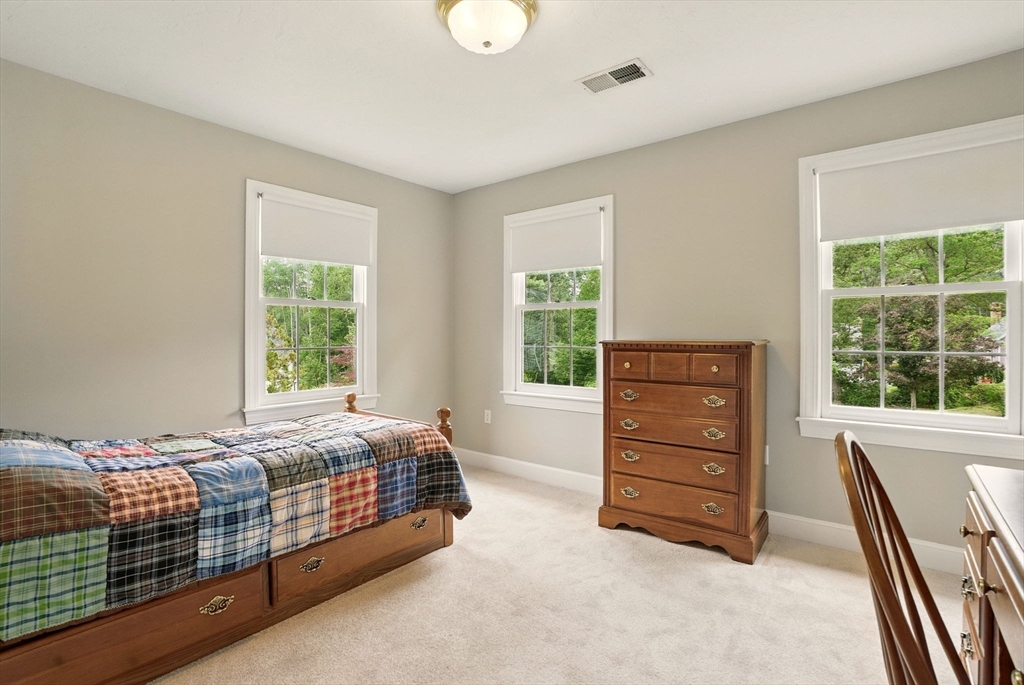 36 Buehler Road Bedford, MA 01730 - Photo 22 of 40 a bedroom with a bed and a dresser