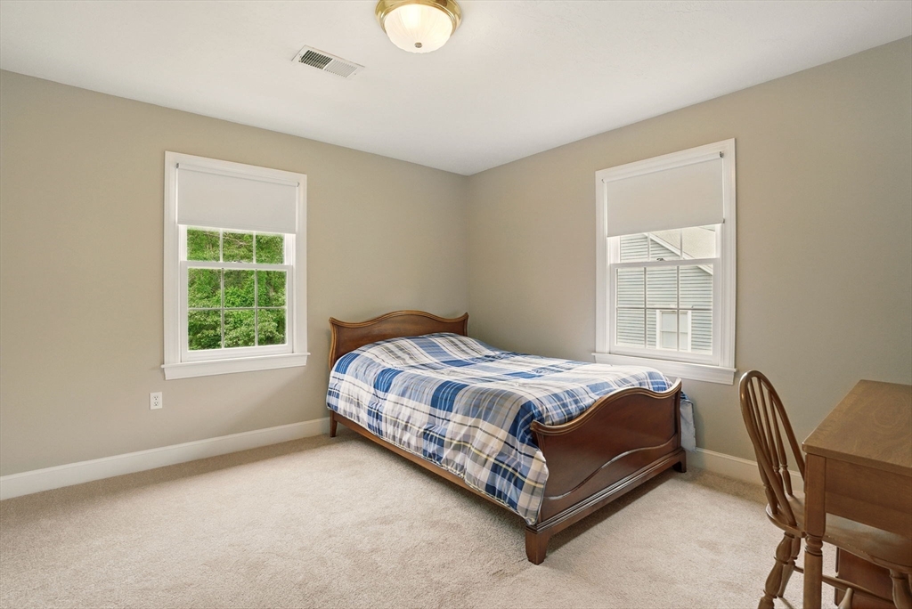 36 Buehler Road Bedford, MA 01730 - Photo 23 of 40 a bed sitting in a bedroom next to a window