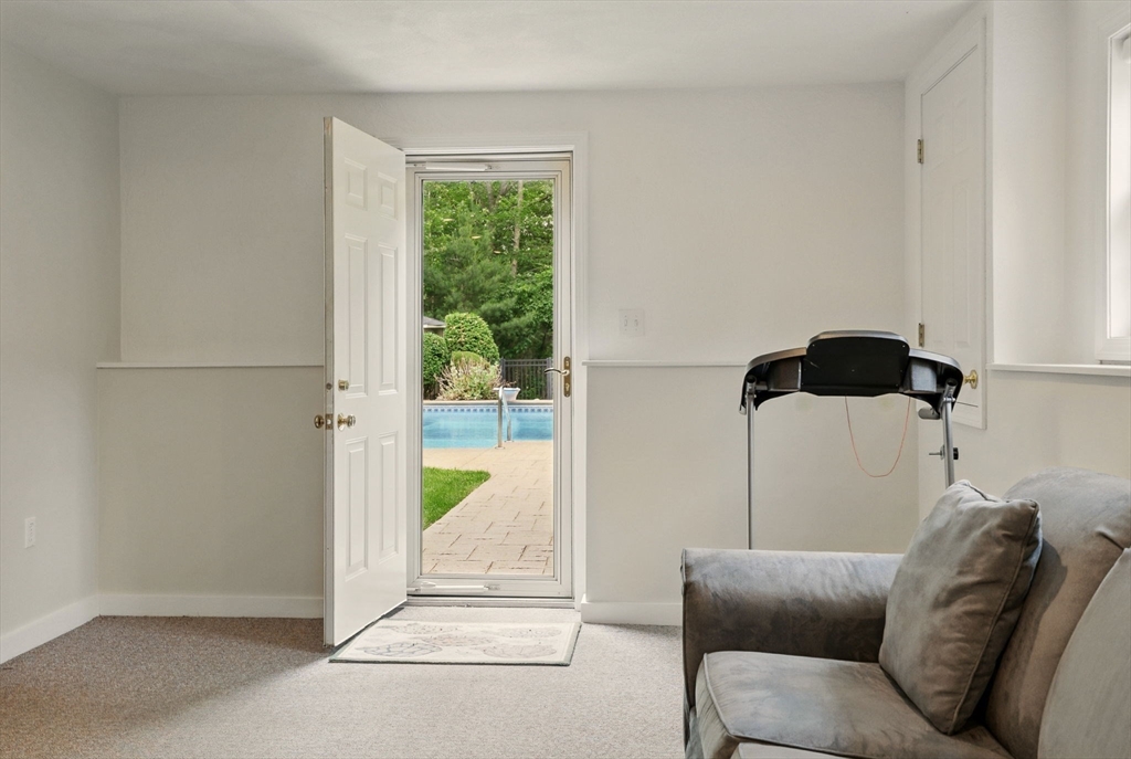 36 Buehler Road Bedford, MA 01730 - Photo 25 of 40 a living room with a couch and a glass door