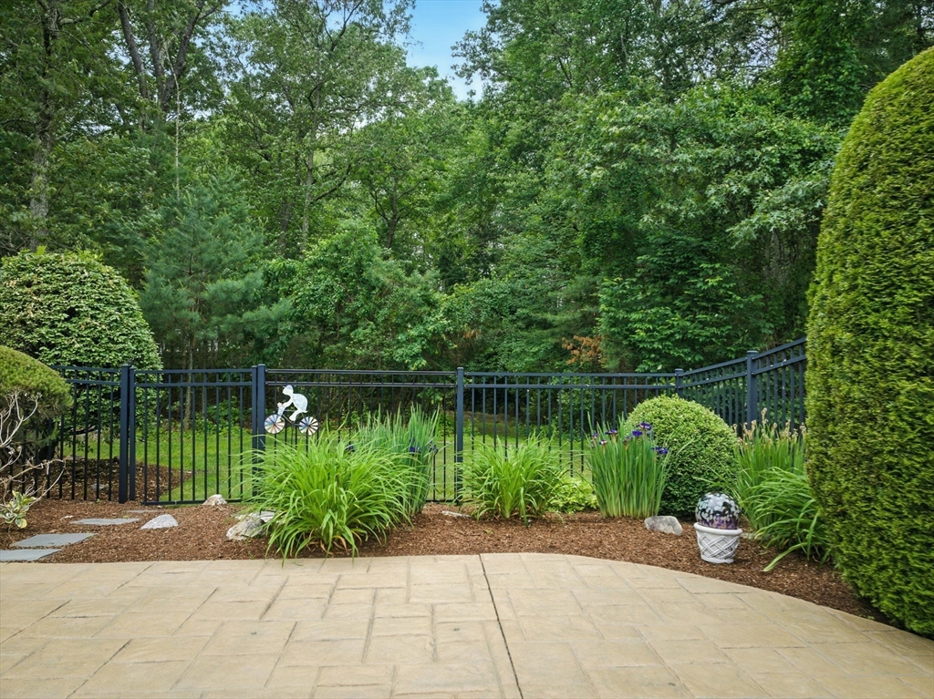 36 Buehler Road Bedford, MA 01730 - Photo 29 of 40 a backyard of a house with lots of green space and lake view