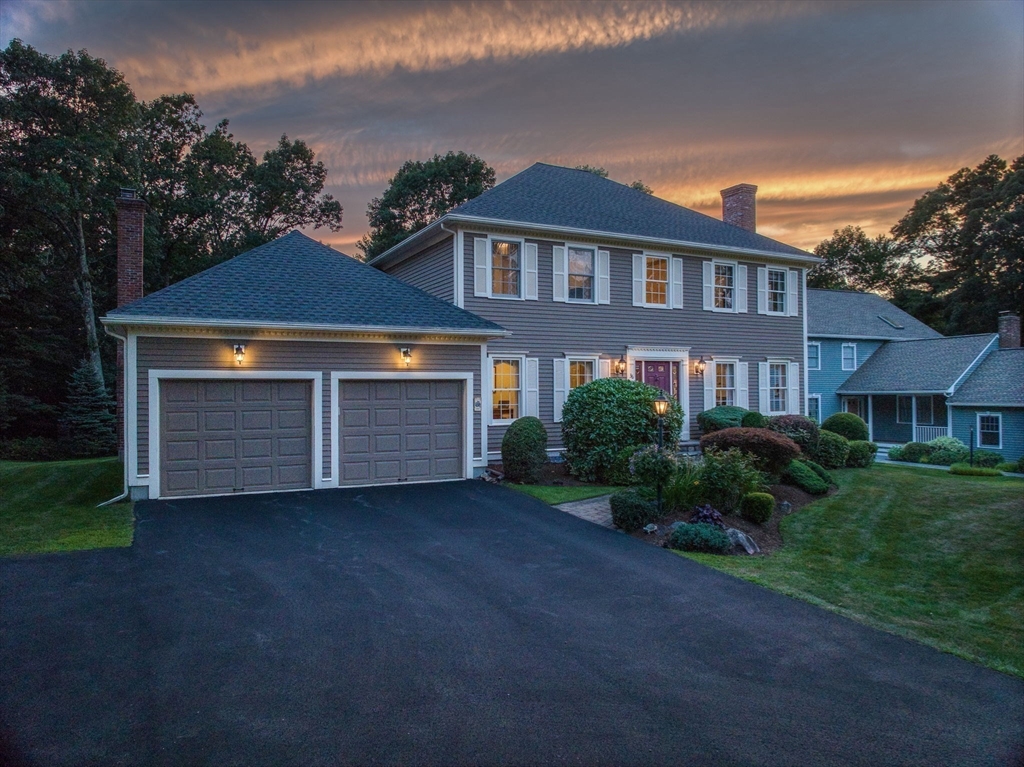 36 Buehler Road Bedford, MA 01730 - Photo 32 of 40 a front view of a house with a yard and garage