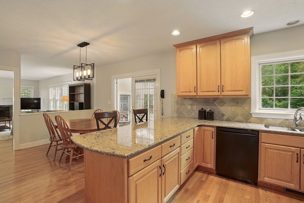 36 Buehler Road Bedford, MA 01730 - Photo 5 of 40 a kitchen with granite countertop a sink a center island and cabinets