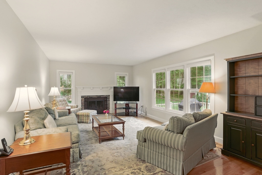 36 Buehler Road Bedford, MA 01730 - Photo 9 of 40 a living room with furniture a fireplace and a large window