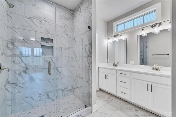 a bathroom with a double vanity sink and mirror