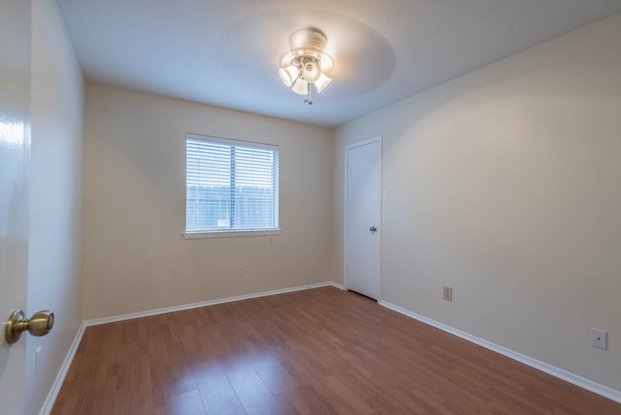 4922 Temple Bell Drive Spring, TX 77388 - Photo 15 of 21 wooden floor in an empty room with a window