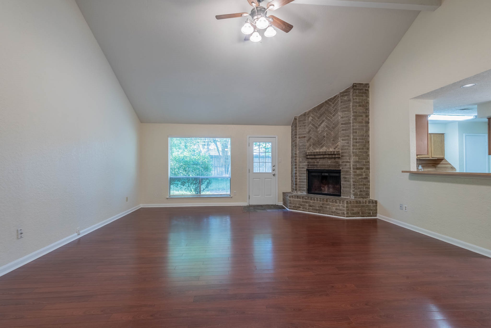 4922 Temple Bell Drive Spring, TX 77388 - Photo 5 of 21 an empty room with wooden floor fireplace and windows