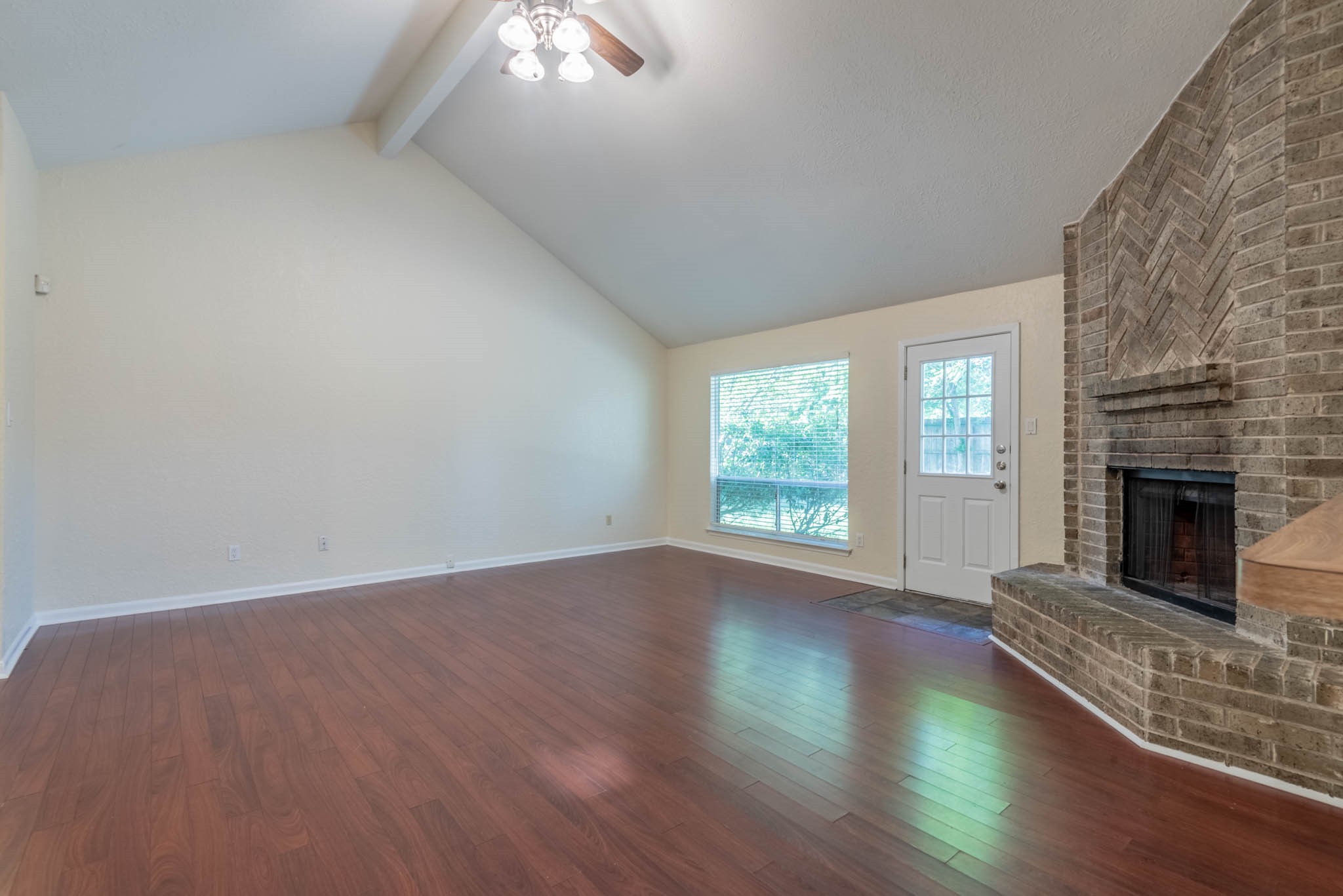 4922 Temple Bell Drive Spring, TX 77388 - Photo 7 of 21 an empty room with wooden floor fireplace and windows