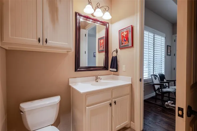 a bathroom with a toilet sink and mirror