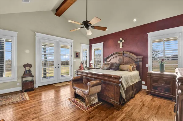 a bedroom with a bed and wooden floor