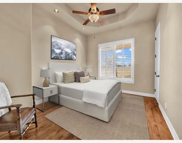 a spacious bedroom with a bed a couch and a window