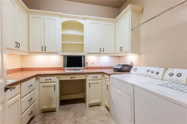 a kitchen with cabinets appliances a sink and a window