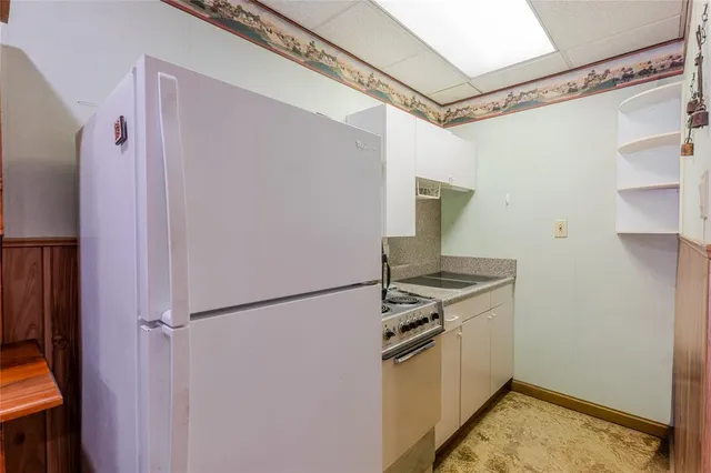 a kitchen with stainless steel appliances granite countertop a refrigerator and a stove