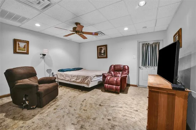 a bedroom with furniture and a flat screen tv