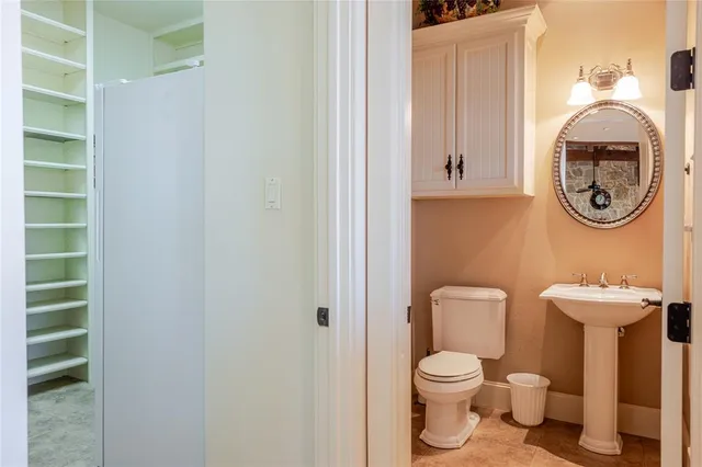 a bathroom with a toilet a sink and a window