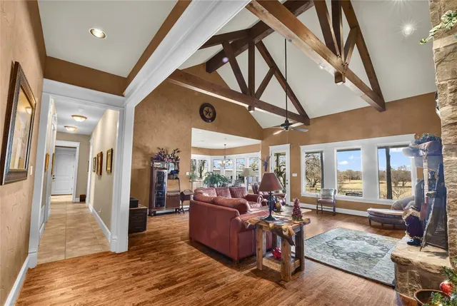 a living room with furniture and a floor to ceiling window