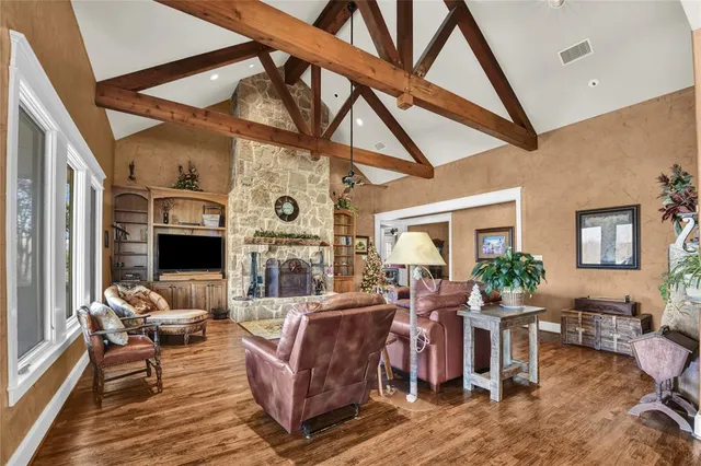 a living room with furniture a flat screen tv and next to a window