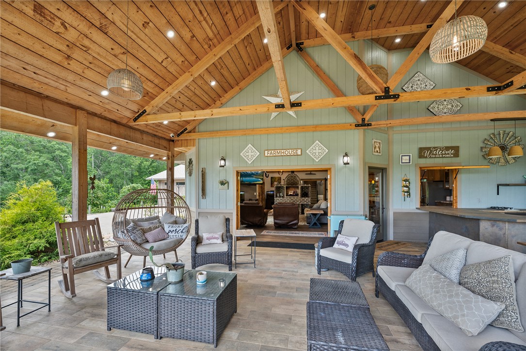 183 Little Eastatoee Road Sunset, SC 29685 - Photo 14 of 50 An inviting outdoor living space features an impressive beamed ceiling and ample seating, perfect for al fresco relaxation.