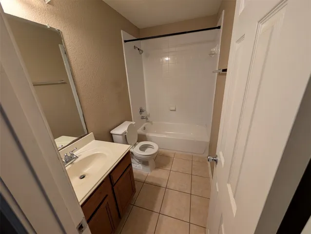 a bathroom with a sink a toilet a mirror and shower