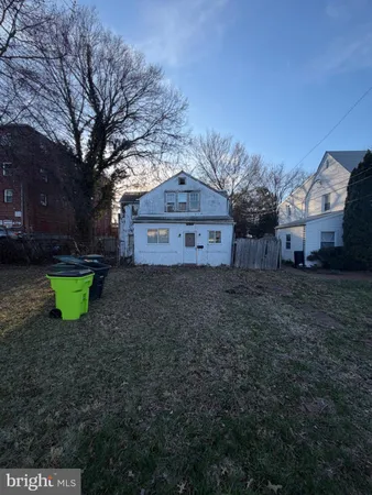 a front view of a house with a garden and yard