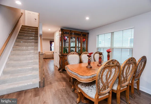 a dining room with furniture and wooden floor