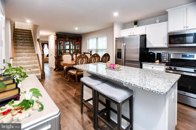 a kitchen with counter space appliances and a dining table