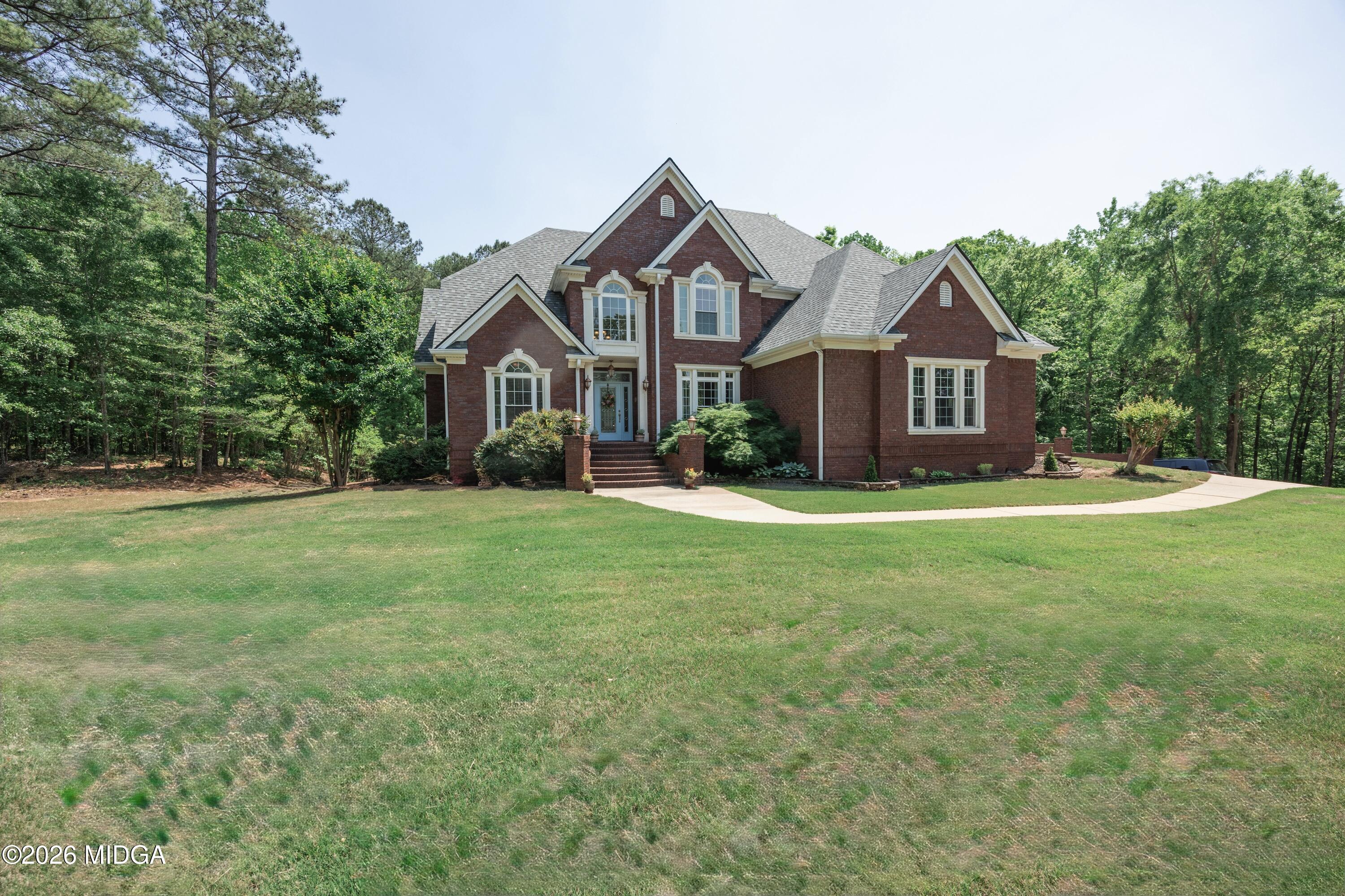102 Tee Drive Forsyth, GA 31029 - Photo 2 of 53 a front view of house with yard and green space