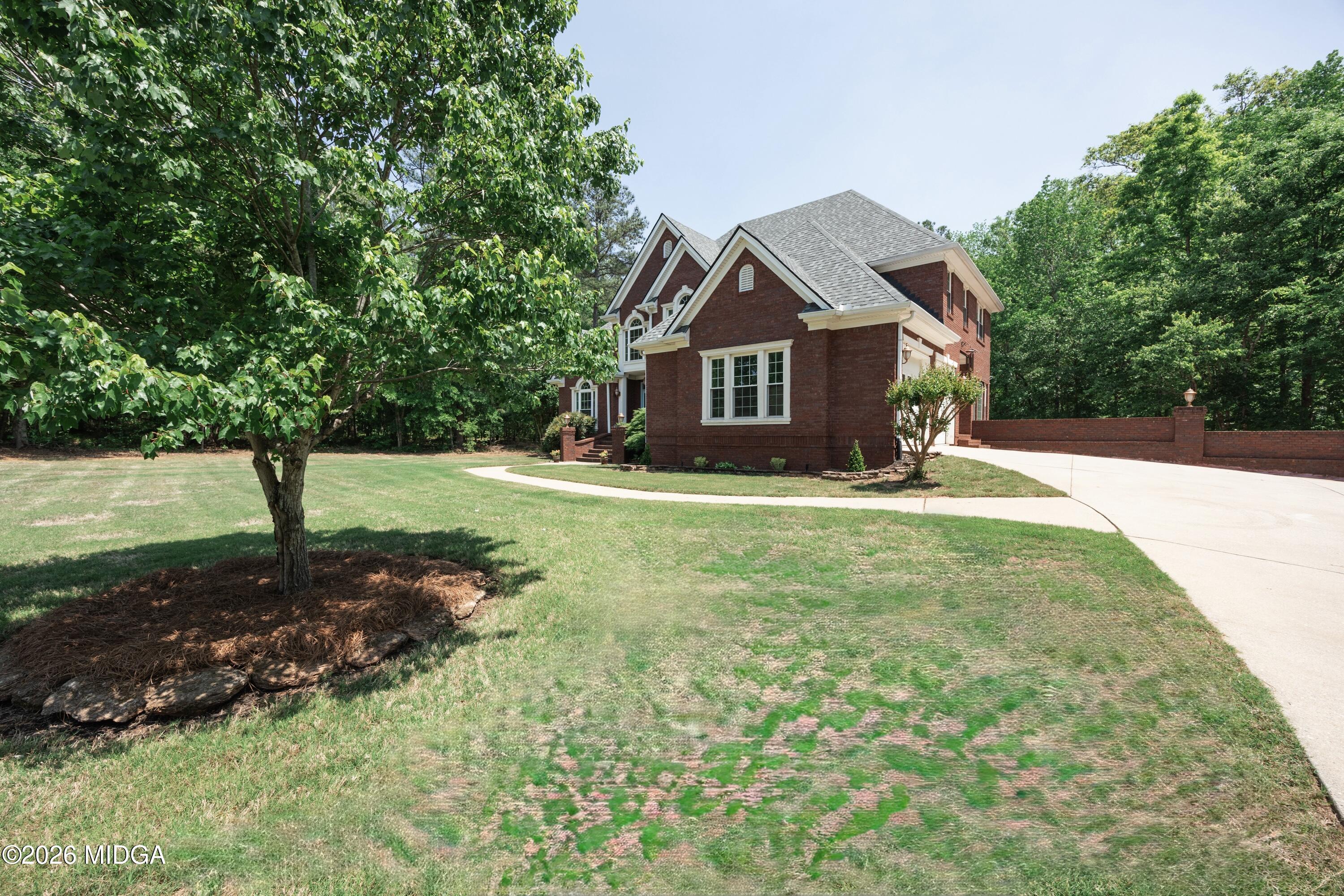102 Tee Drive Forsyth, GA 31029 - Photo 3 of 53 a front view of a house with yard and green space