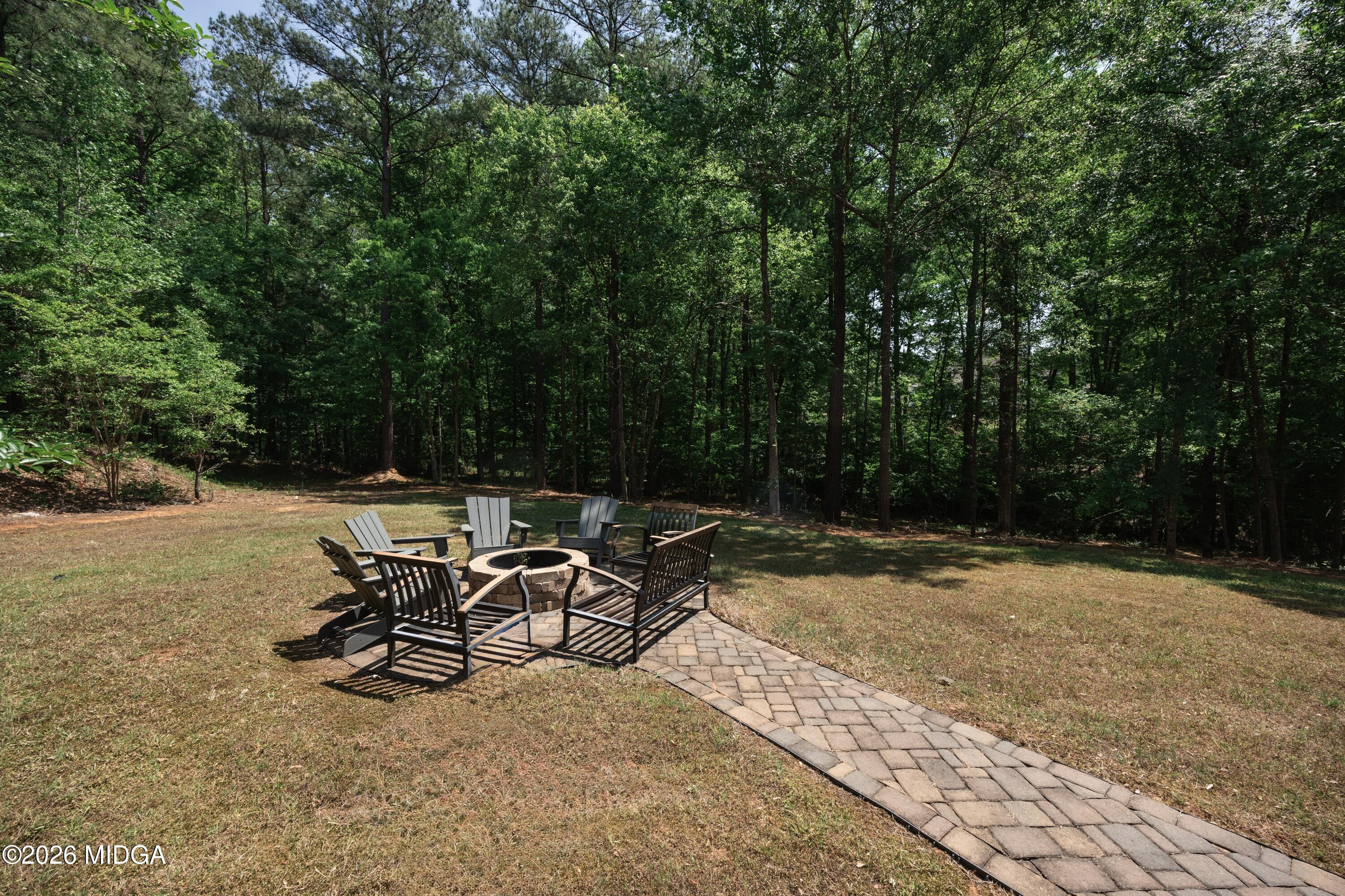 102 Tee Drive Forsyth, GA 31029 - Photo 49 of 53 a view of a backyard with table and chairs and a small yard