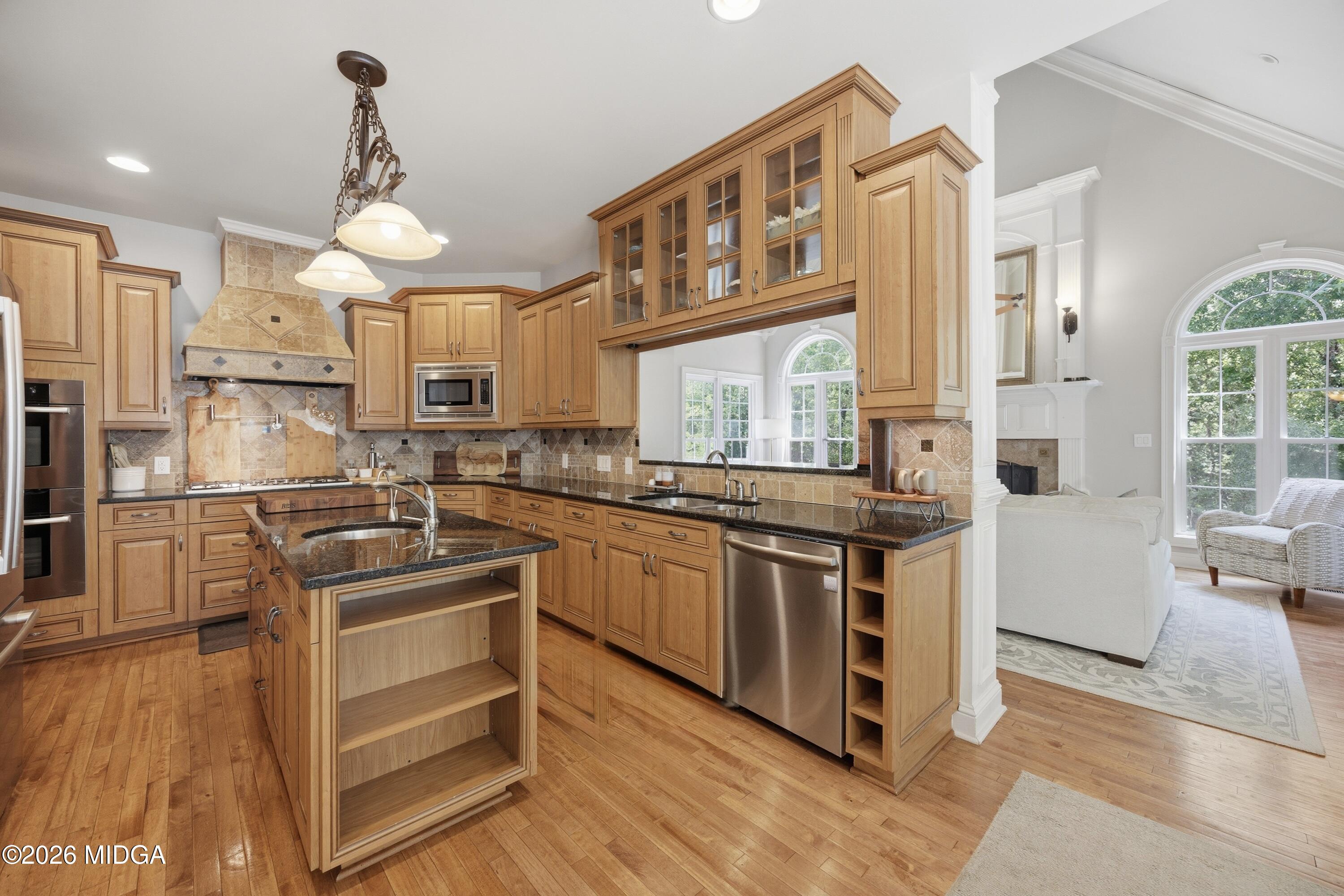 102 Tee Drive Forsyth, GA 31029 - Photo 5 of 53 a kitchen with stainless steel appliances granite countertop a stove and a refrigerator