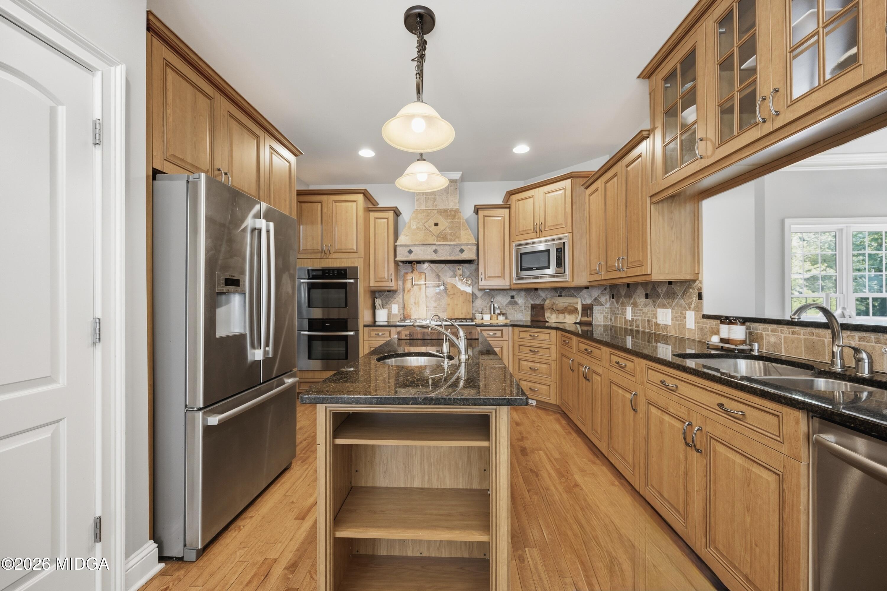 102 Tee Drive Forsyth, GA 31029 - Photo 6 of 53 a kitchen with stainless steel appliances granite countertop a refrigerator and a sink