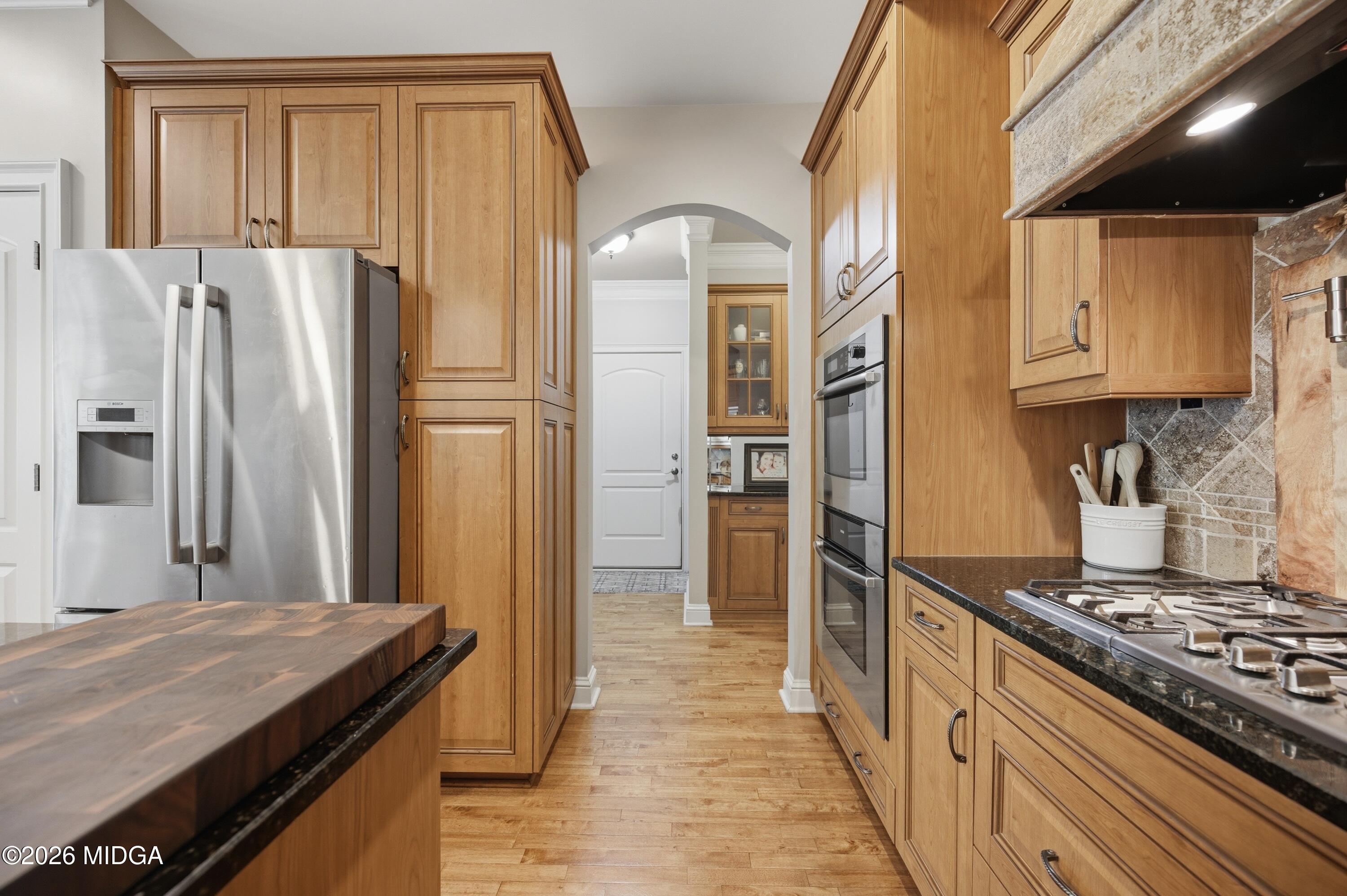 102 Tee Drive Forsyth, GA 31029 - Photo 8 of 53 a kitchen with stainless steel appliances granite countertop a refrigerator and a stove