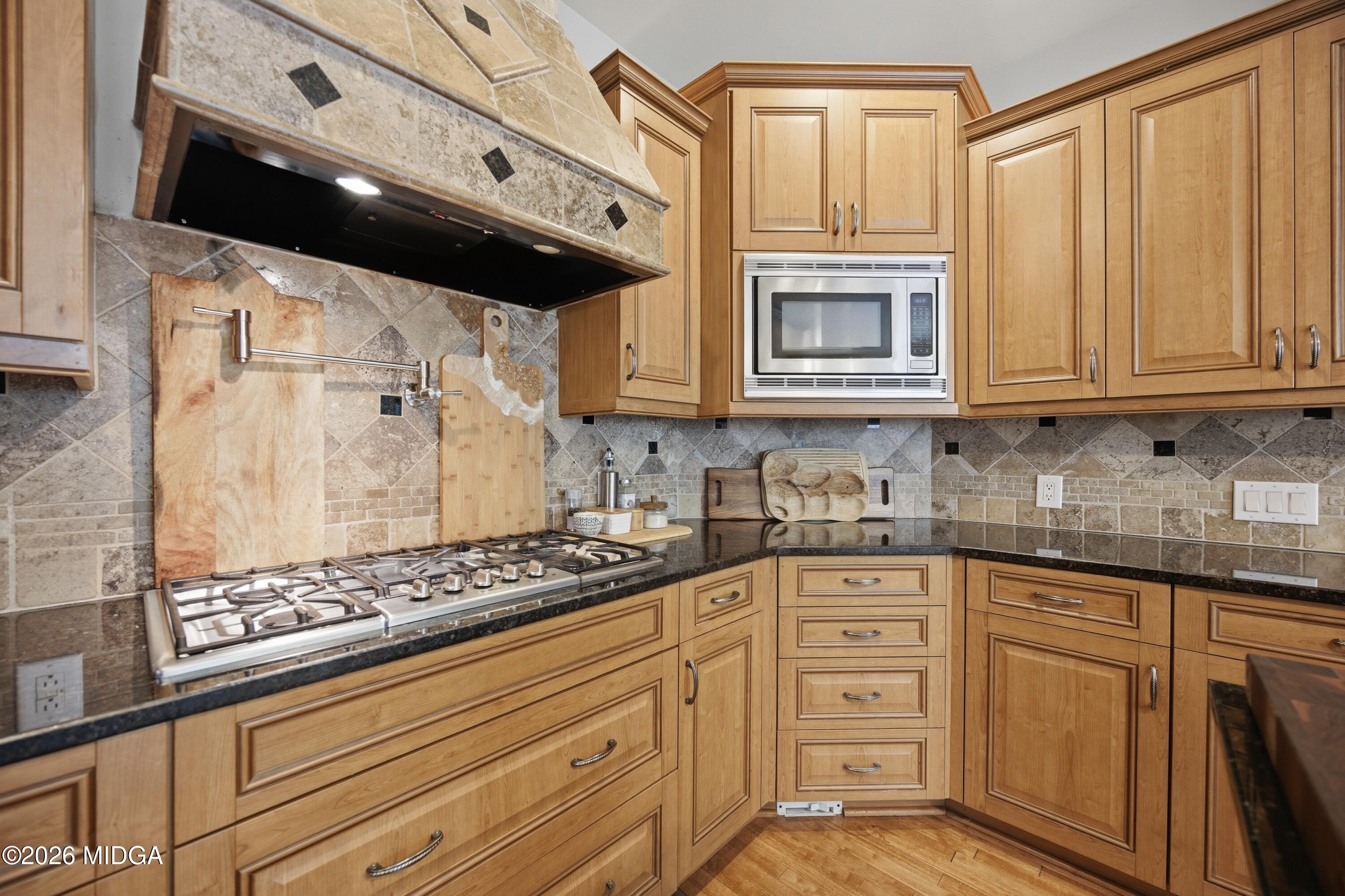 102 Tee Drive Forsyth, GA 31029 - Photo 10 of 53 a kitchen with stainless steel appliances granite countertop a stove and a microwave