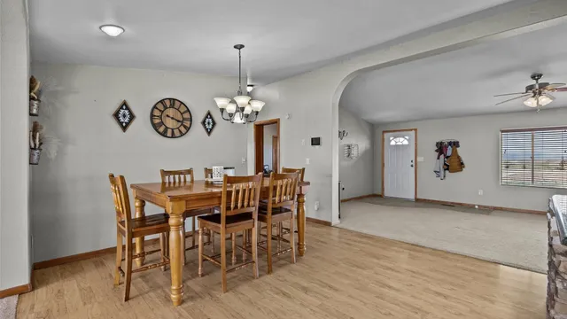 a kitchen with stainless steel appliances granite countertop a stove a sink dishwasher and refrigerator with wooden floor