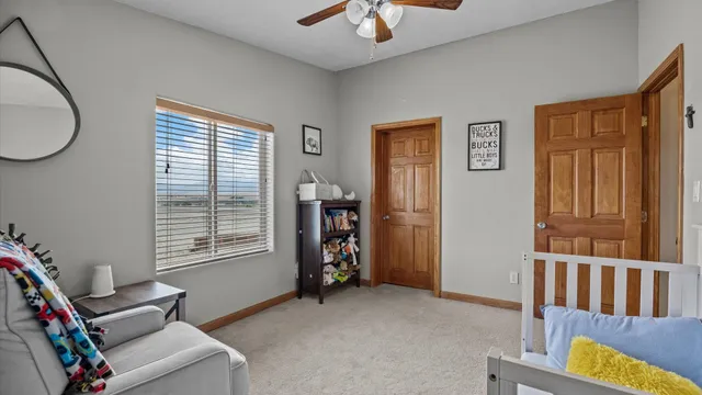 a bathroom with a granite countertop sink a toilet and a mirror