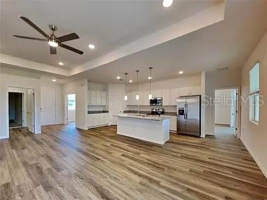 23414 Racine Avenue Port Charlotte, FL 33980 - Photo 5 of 12 a view of kitchen with kitchen island wooden floor center island and stainless steel appliances