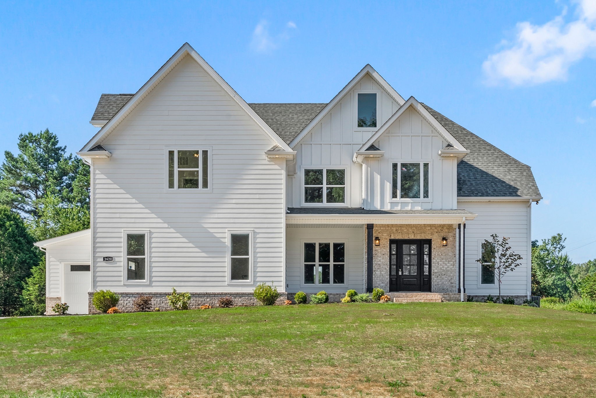 a front view of a house with a yard