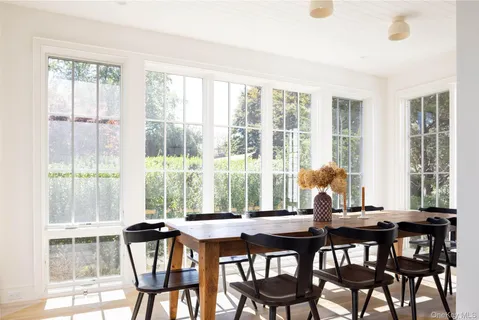 a view of a dining room with furniture and windows