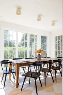 a dining room with furniture and wooden floor