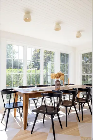 a dining room with furniture and wooden floor