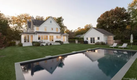 a view of house with a yard and lake view
