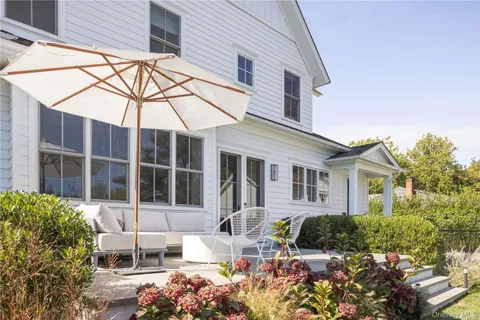 a view of a patio with couches chairs and a potted plant