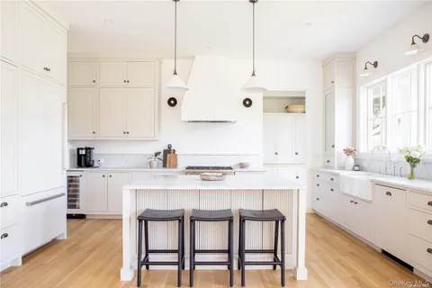 a kitchen with a table chairs sink and cabinets