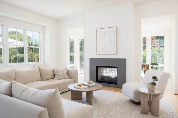 a living room with furniture a fireplace and window