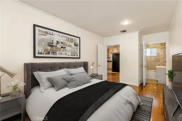 a bedroom with bed and large window